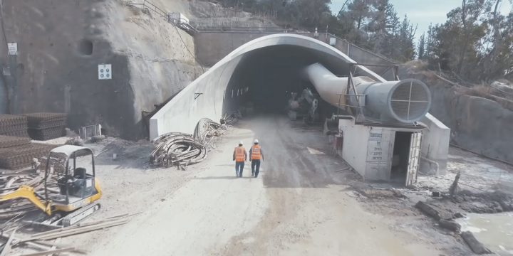 Men standing outside a mining tunnel